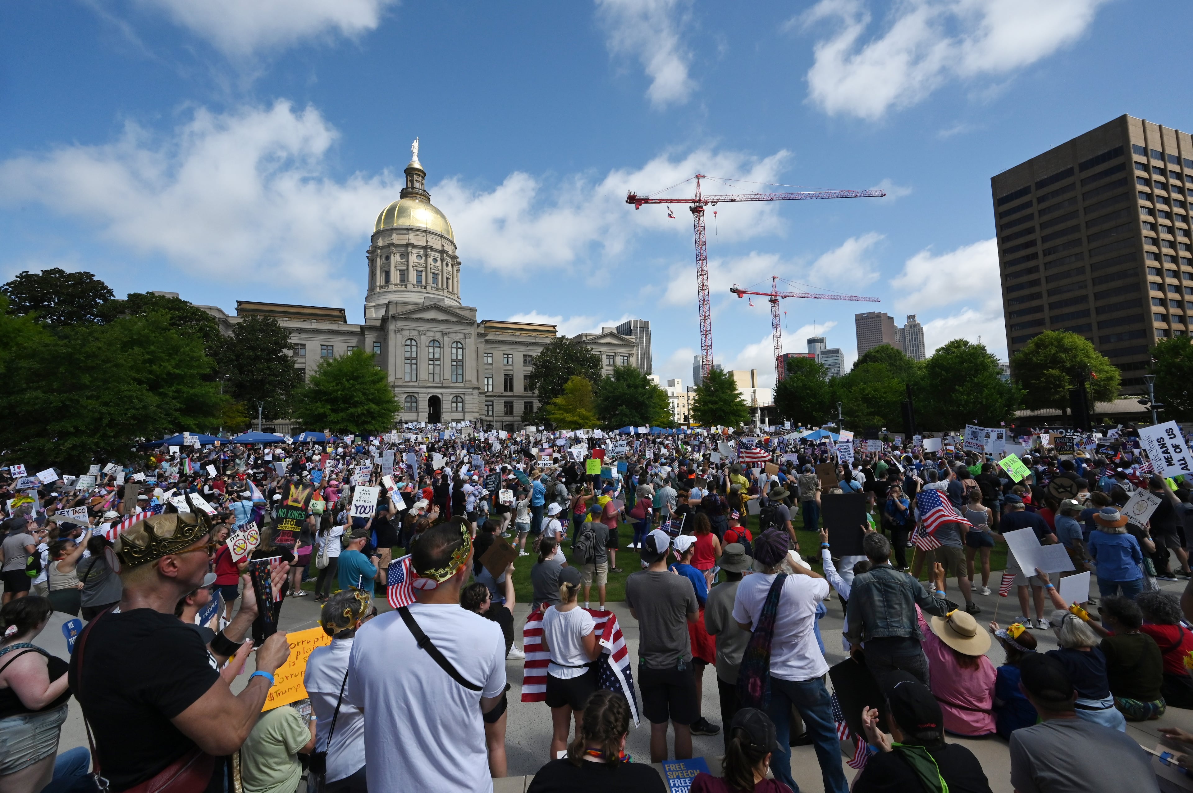 Demonstrators gather at Liberty Plaza, near the Georgia Capitol, for a "No Kings" protest to oppose Trump’s immigration policies, Saturday, June 14, 2025, in Atlanta. (Hyosub Shin / AJC)