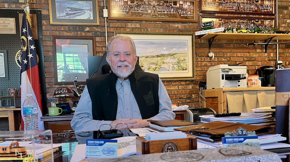 Former state Rep. Terry England sits behind his desk from the state Capitol at his home office in his Auburn, Ga, on Nov. 19, 2025. (Patricia Murphy/AJC)