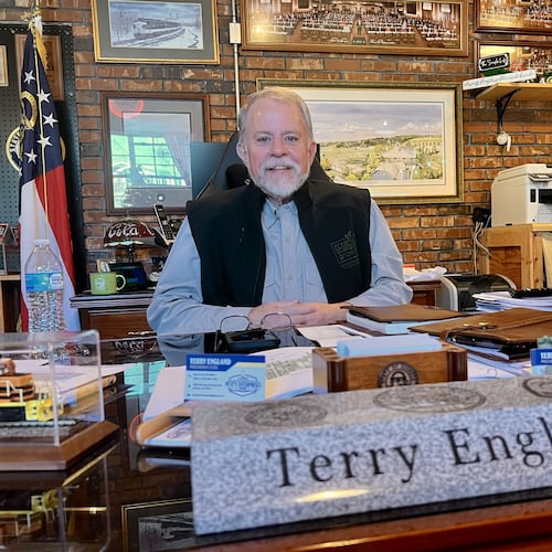 Former state Rep. Terry England sits behind his desk from the state Capitol at his home office in his Auburn, Ga, on Nov. 19, 2025. (Patricia Murphy/AJC)
