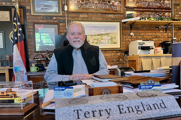 Former state Rep. Terry England sits behind his desk from the state Capitol at his home office in his Auburn, Ga, on Nov. 19, 2025. (Patricia Murphy/AJC)