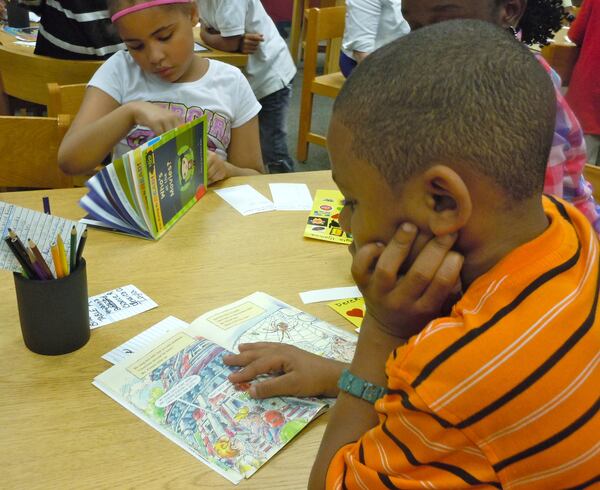 Atlanta Public Schools students enjoy their reading time with Children's Literature for Children volunteers. Courtesy of Children's Literature for Children