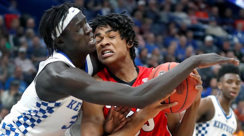 Georgia's Nicolas Claxton, right, collides with Kentucky's Wenyen Gabriel during the first half of an NCAA college basketball quarterfinal game at the Southeastern Conference tournament Friday, March 9, 2018, in St. Louis. (AP Photo/Jeff Roberson)