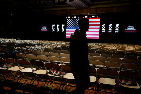 A man walks in a convention center before a town hall with Elon Musk, Sunday, March 30, 2025, in Green Bay, Wis. (AP Photo/Jeffrey Phelps)