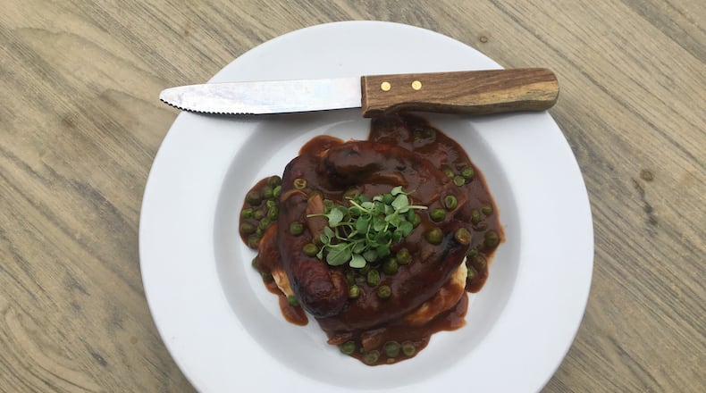 Grilled bangers and mash with English peas and gravy at Meehan's Public House. / PHOTO CREDIT: Meehan's Public House