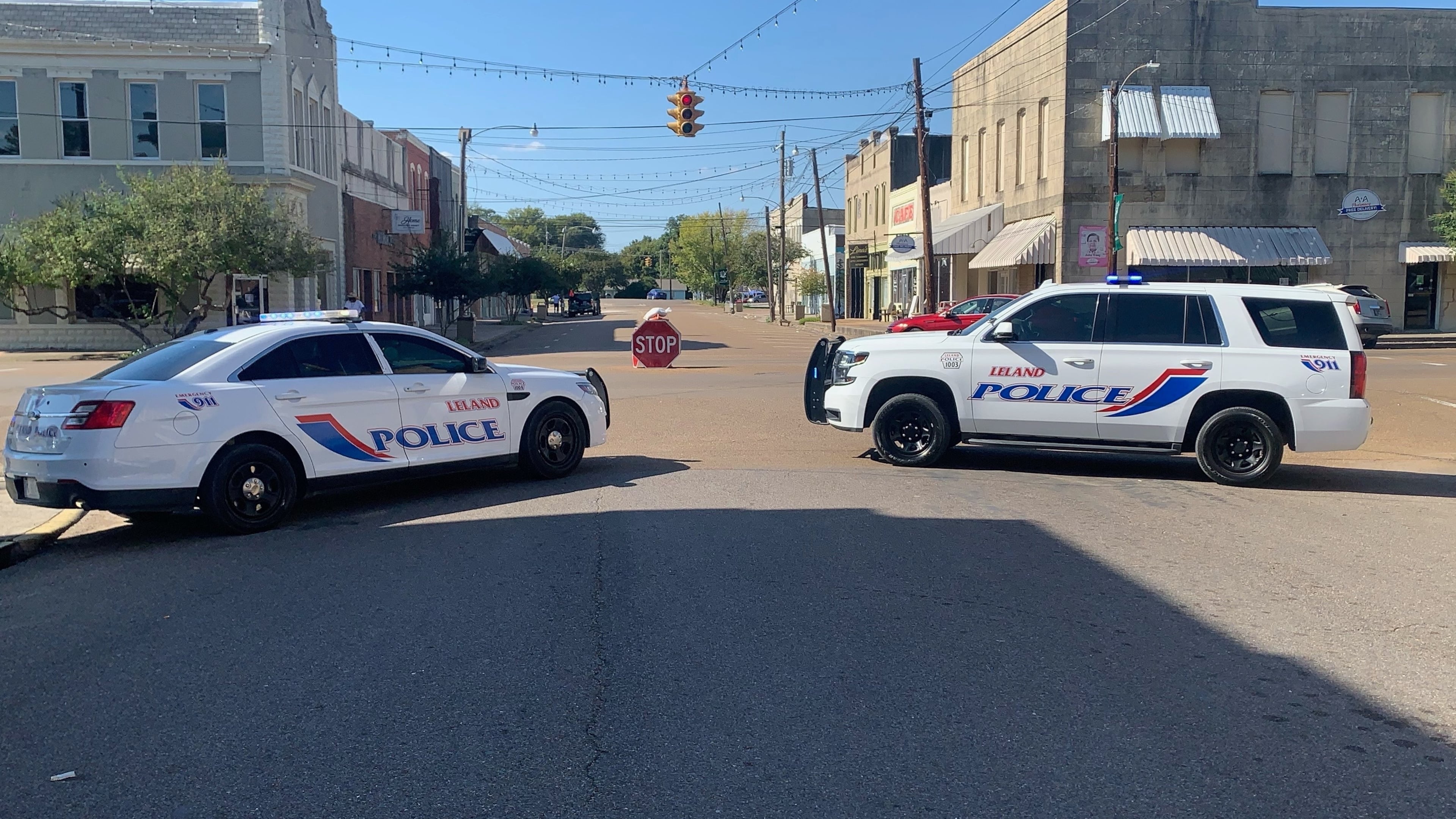 Police vehicles are parked after a deadly shooting Friday night in downtown Leland, Miss.,on Saturday, Oct. 11, 2025. (AP Photo/Katie Adkins)