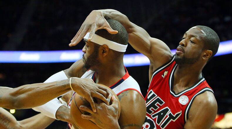 022013 ATLANTA: Miami Heat Dwyane Wade helps double team Atlanta Hawks Josh Smith during the first half of a NBA game on Wednesday, Feb. 20, 2013, in Atlanta. CURTIS COMPTON / CCOMPTON@AJC.COM