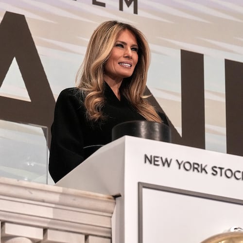 First lady Melania Trump poses for photos on the podium after ringing the New York Stock Exchange opening bell, Wednesday, Jan. 28, 2026. (AP Photo/Richard Drew)