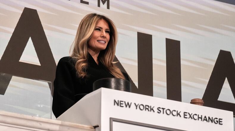 First lady Melania Trump poses for photos on the podium after ringing the New York Stock Exchange opening bell, Wednesday, Jan. 28, 2026. (AP Photo/Richard Drew)