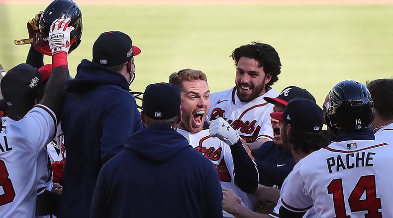 That's Freddie Freeman in the middle of the celebration after his walk-off single that beat Cincinnati in Game One of their wild card series.   “Curtis Compton / Curtis.Compton@ajc.com”
