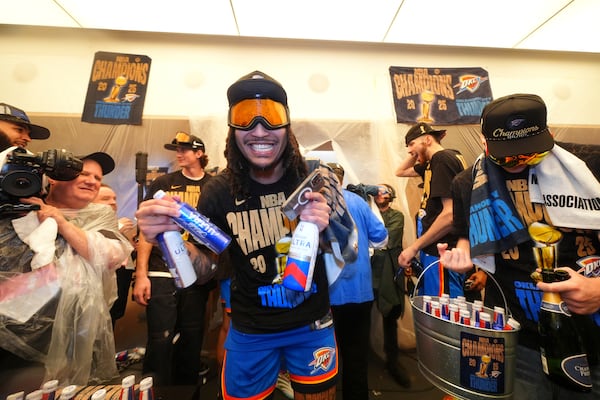 Oklahoma City Thunder forward Jaylin Williams celebrates with teammates in the locker room after winning the NBA basketball championship with a Game 7 victory against the Indiana Pacers Sunday, June 22, 2025, in Oklahoma City. (AP Photo/Julio Cortez)