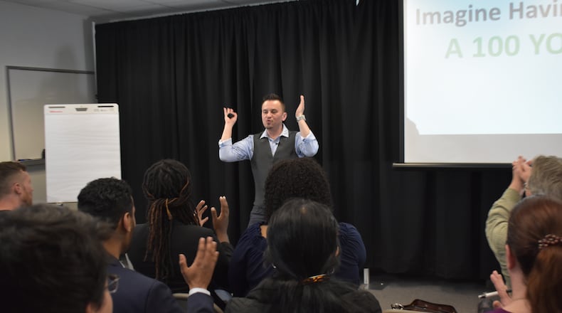 Ariel Ghinga, founder of Atlanta Public Speaking, shows how gestures and understanding someone’s body language are an integral part of a conversation. (Courtesy of Ariel Ghinga)