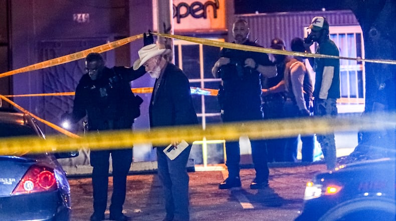 Authorities investigate a fatal shooting in the 250 block of Trinity Avenue on March 22. John Spink / John.Spink@ajc.com