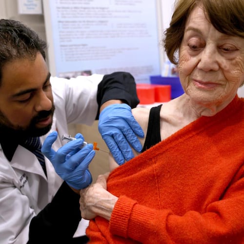 Dr. Gaurav Shinde (left) gives Giti Noroozi, 85, vaccinations for COVID and the flu at a California pharmacy in 2024. It is recommended that older adults get flu shots, as they are at a higher risk for hospitalization or death from the flu. (Genaro Molina/TNS 2024)