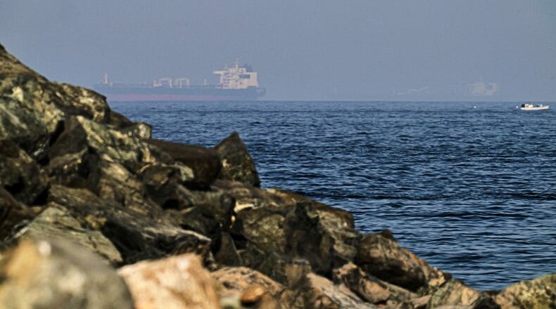 FILE - Cargo ships are seen at sea in the Gulf of Oman near the Strait of Hormuz, from a rocky shoreline near Khor Fakkan, United Arab Emirates, May 1, 2026. (AP Photo/Fatima Shbair, File)