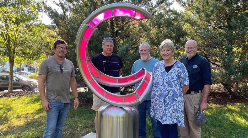 Arts Alpharetta board members and city employees with artist Nathan Pierce following the installation of his sculpture, Allura. (Courtesy Arts Alpharetta)