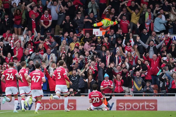 Wrexham's Oliver Rathbone, right, celebrates with teammates after scoring his side's opening goal during the English League One soccer match between Wrexham and Charlton Athletic at the Racecourse ground in Wrexham, Wales, Saturday, April 26, 2025. (AP Photo/Jon Super)