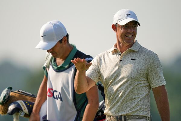 Rory McIlroy, of Northern Ireland, walks up to the 13th tee with his caddie, Harry Diamond, left, during the first round of the U.S. Open golf tournament at Oakmont Country Club Thursday, June 12, 2025, in Oakmont, Pa. (AP Photo/Carolyn Kaster)