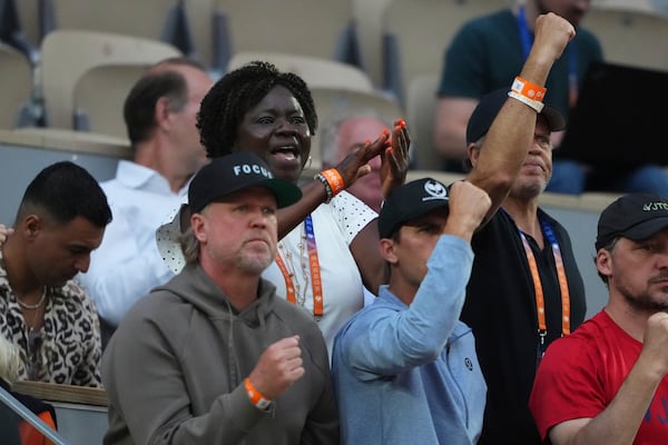 Alphina Tamara, top left, mother of Frances Tiafoe, celebrates his son's win over Germany's Daniel Altmaier during their fourth round match of the French Tennis Open, at the Roland-Garros stadium, in Paris, Sunday, June 1 2025. (AP Photo/Lindsey Wasson)