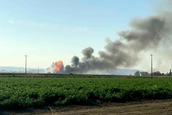 In this image taken from video, smoke and flames rise from a fireworks warehouse explosion, July 1, 2025, in Esparto, Calif. (Hudson Sheats via AP)