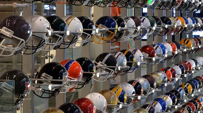 A 40-foot-high wall with more than 700 football helmets representing every Division I, Division II, Division III and NAIA program highlight The Quad in the new College Football Hall of Fame in Atlanta. BRANT SANDERLIN /BSANDERLIN@AJC.COM