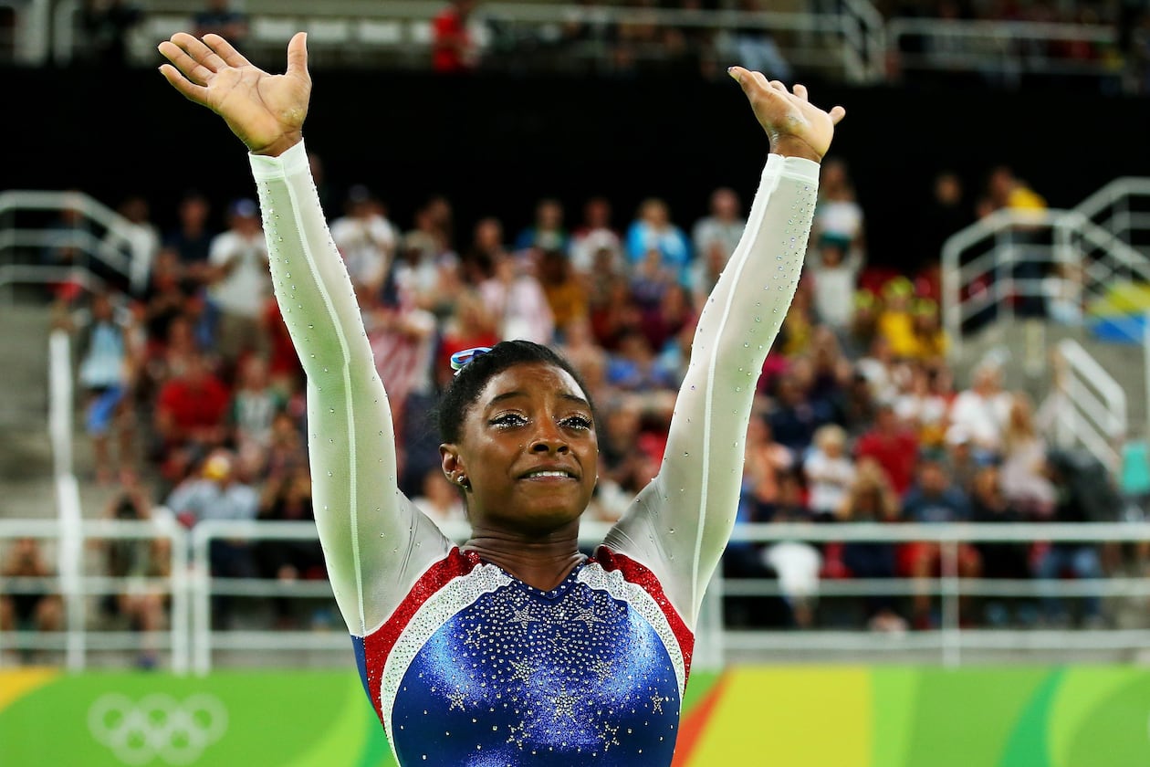 RIO DE JANEIRO, BRAZIL - AUGUST 11: Simone Biles of the United States waves to fans after winning the gold medal during the Women’s Individual All Around Final on Day 6 of the 2016 Rio Olympics at Rio Olympic Arena on August 11, 2016 in Rio de Janeiro, Brazil. (Photo by Alex Livesey/Getty Images)