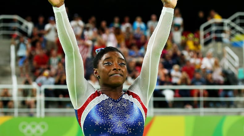 RIO DE JANEIRO, BRAZIL - AUGUST 11: Simone Biles of the United States waves to fans after winning the gold medal during the Women’s Individual All Around Final on Day 6 of the 2016 Rio Olympics at Rio Olympic Arena on August 11, 2016 in Rio de Janeiro, Brazil. (Photo by Alex Livesey/Getty Images)