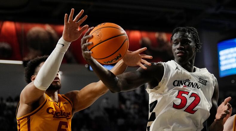 Iowa State Cyclones Joshua Jefferson (5) and Cincinnati center Moustapha Thiam (52) battle for a rebound during the first half of an NCAA college basketball game, Saturday, Jan. 17, 2026, in Cincinnati. (AP Photo/Carolyn Kaster)