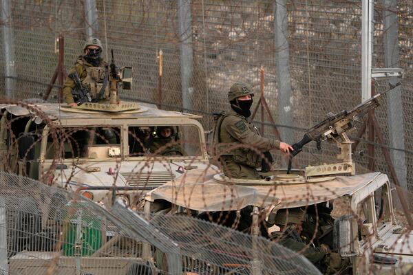 FILE - Israeli soldiers stand on armoured vehicles after crossing the security fence near the so-called Alpha Line that separates the Israeli-controlled Golan Heights from Syria, in the town of Majdal Shams, Dec. 21, 2024. (AP Photo/Matias Delacroix, File)