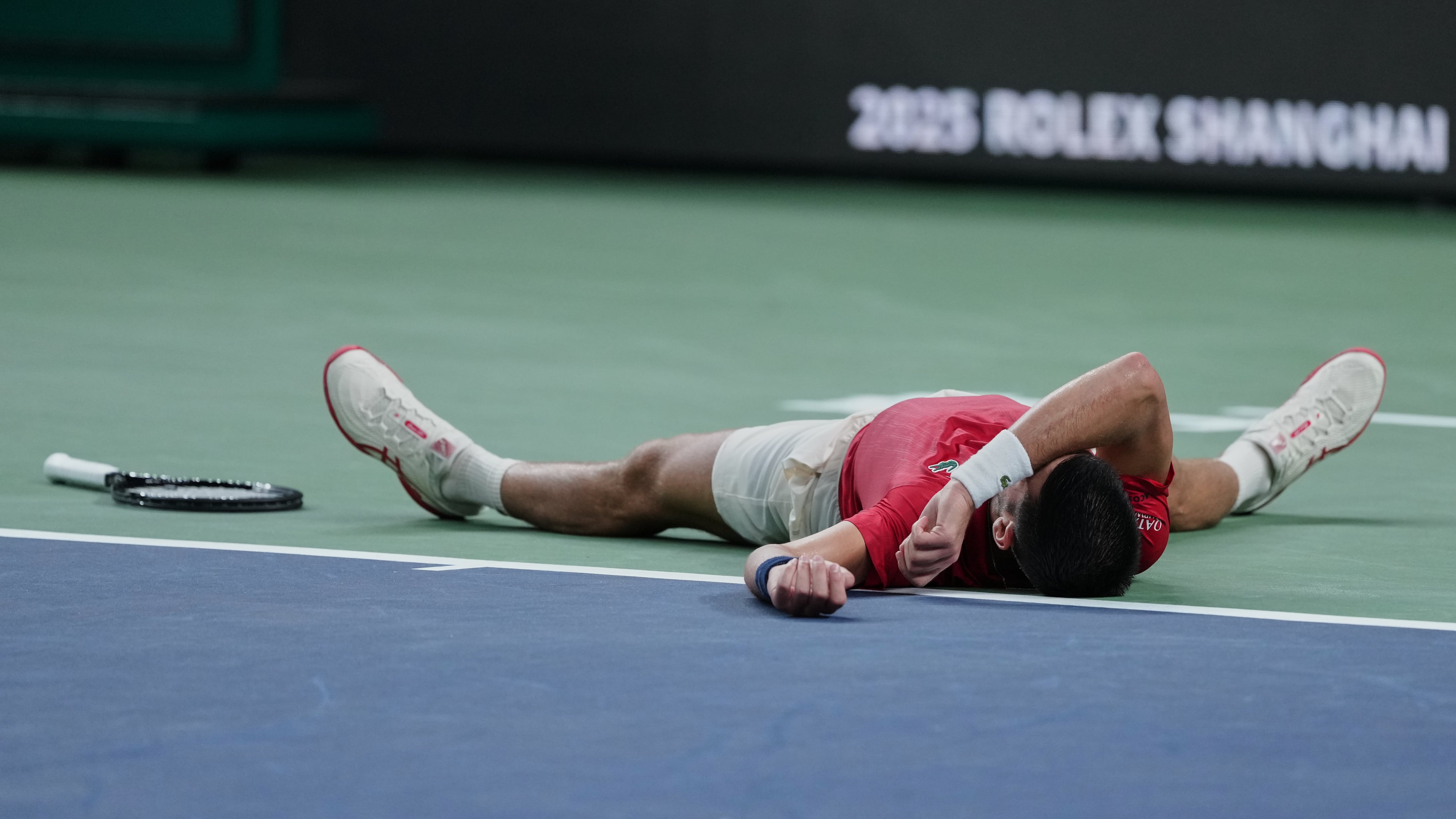 Novak Djokovic of Serbia reacts after losing the second set point to Jaume Munar of Spain during the men's singles match of the Shanghai Masters tennis tournament at Qizhong Forest Sports City Tennis Center, in Shanghai, China, Tuesday, Oct. 7, 2025. (AP Photo/Andy Wong)