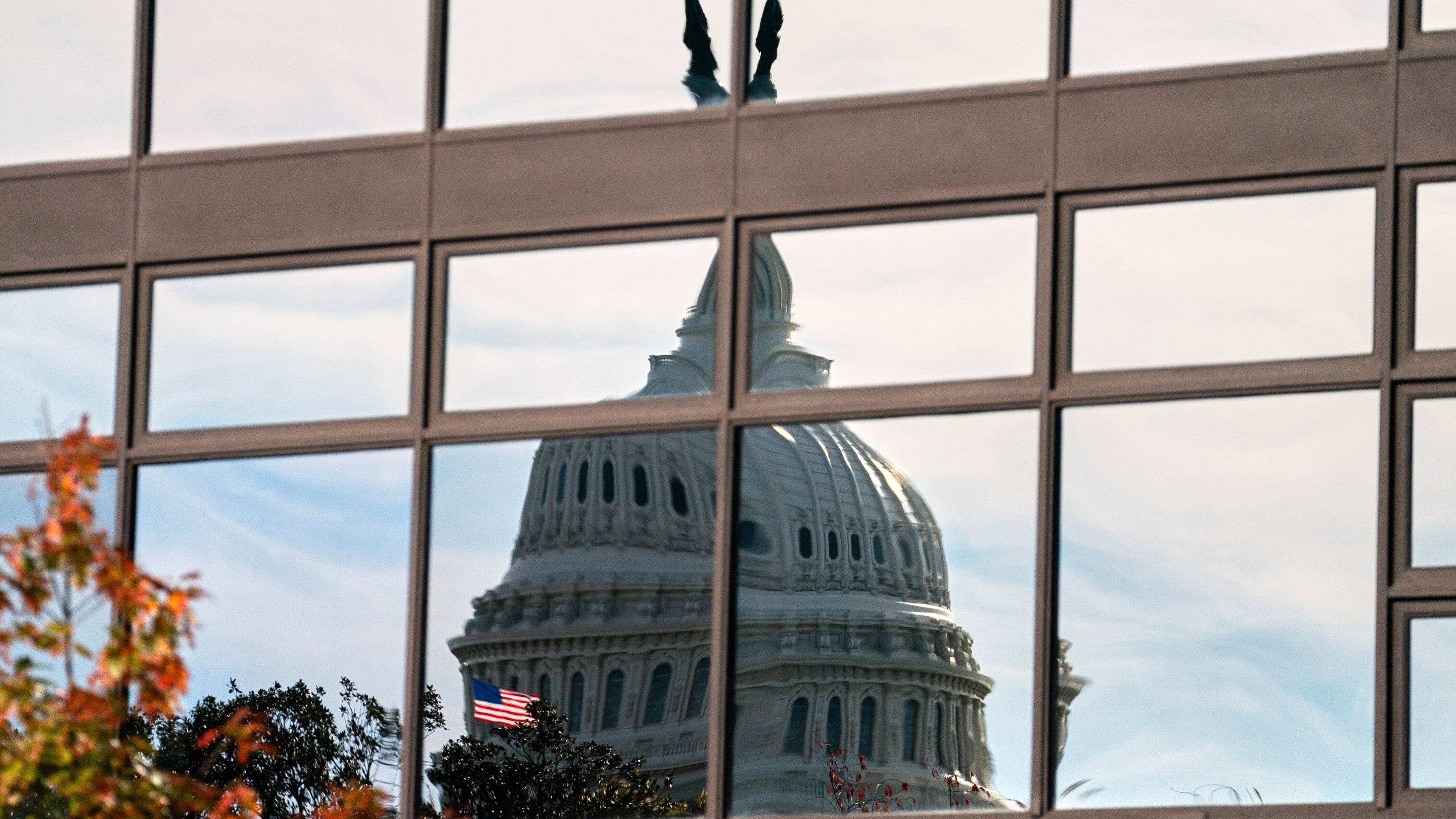 The Capitol dome is distorted by windows on the teamster's building, Tuesday, Nov. 4, 2025, in Washington. (AP Photo/Allison Robbert)