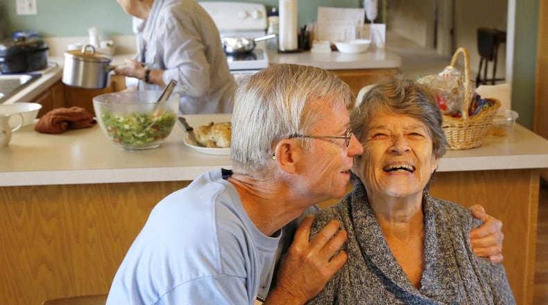 Bill Kelly, 64, gives Jackie Kindl, 81, a hug at lunch in Lombard, Illinois, on Thursday, September 26, 2013. Self-sufficient seniors share a house in a residential neighborhood in Lombard, one of four share houses run by the non-profit Senior Housing Share.