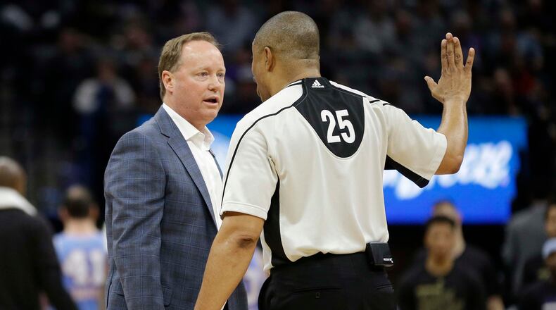 Atlanta Hawks head coach Mike Budenholzer, left, questions referee Tony Brothers about a call during the second half of an NBA basketball game against the Sacramento Kings Friday, Feb. 10, 2017, in Sacramento, Calif. The Kings won 108-107. (AP Photo/Rich Pedroncelli)
