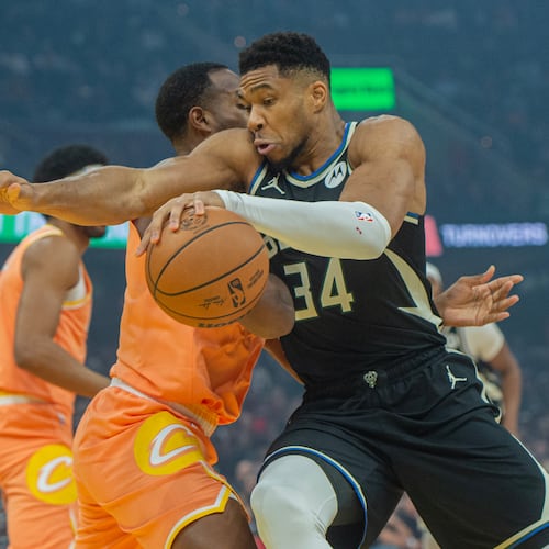 Milwaukee Bucks' Giannis Antetokounmpo (34) drives to the basket as Cleveland Cavaliers' Evan Mobley, second from right, defends during the first half of an NBA basketball game in Cleveland, Monday, Nov. 17, 2025. (AP Photo/Phil Long)