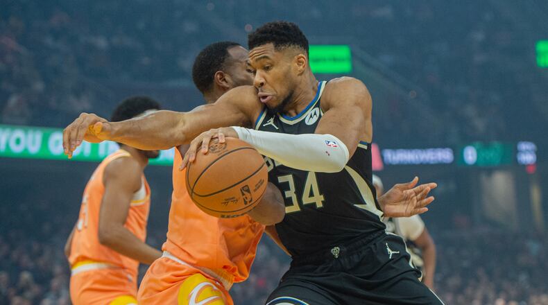 Milwaukee Bucks' Giannis Antetokounmpo (34) drives to the basket as Cleveland Cavaliers' Evan Mobley, second from right, defends during the first half of an NBA basketball game in Cleveland, Monday, Nov. 17, 2025. (AP Photo/Phil Long)