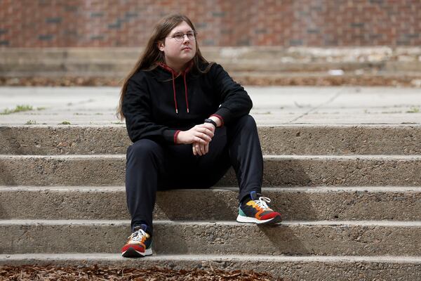 Glenn Thompson, a Durham School of the Arts graduate, poses in front of the school in Durham, N.C., Monday, March 10, 2025. (AP Photo/Karl DeBlaker)