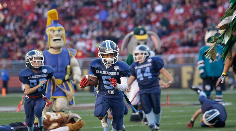A pint-sized back has his moment during halftime of a San Francisco 49ers-Arizona Cardinals game. (AP Photo/Marcio Jose Sanchez, File)
