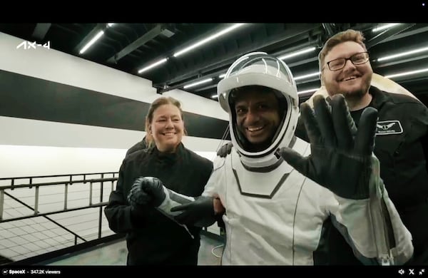 In this image made from video provided by SpaceX, one of the four astronauts, India's Shubhanshu Shukla, waves as he comes out of a SpaceX capsule loaded at the recovery ship after parachuting into the Pacific Ocean off the coast of Southern California on Tuesday, July 15, 2025. (SpaceX via AP)