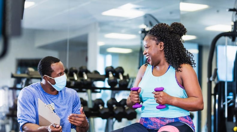 A coach offers fitness tips and support at the YMCA of Metro Atlanta. (FILE/Courtesy of the YMCA of Metro Atlanta)