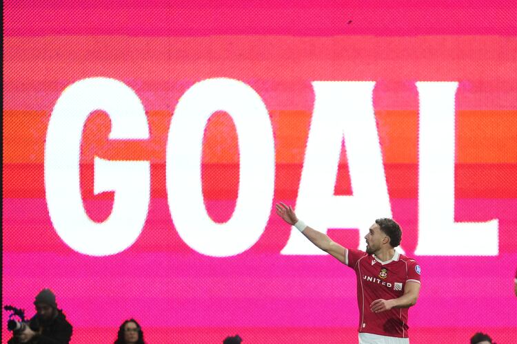Wrexham's Sam Smith celebrates after scoring during the fifth round FA Cup soccer match between Wrexham and Chelsea in Wrexham, Wales, Saturday, March 7, 2026. (AP Photo/Jon Super)