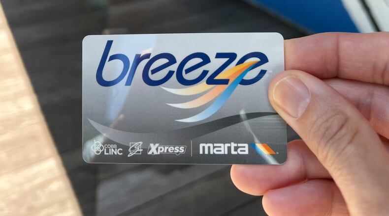 A MARTA rider holds his Breeze transit card. (David Plazas/AJC 2025)