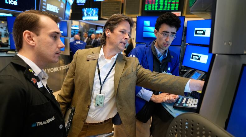 Patrick McKeon, center, works on the floor at the New York Stock Exchange in New York, Tuesday, March 31, 2026. (AP Photo/Seth Wenig)