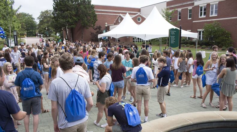 Students and parents gather around the fountain at Georgia College, which hosted its second freshmen orientation out of five for the summer on Friday, June 15. Jenna Eason / Jenna.Eason@coxinc.com