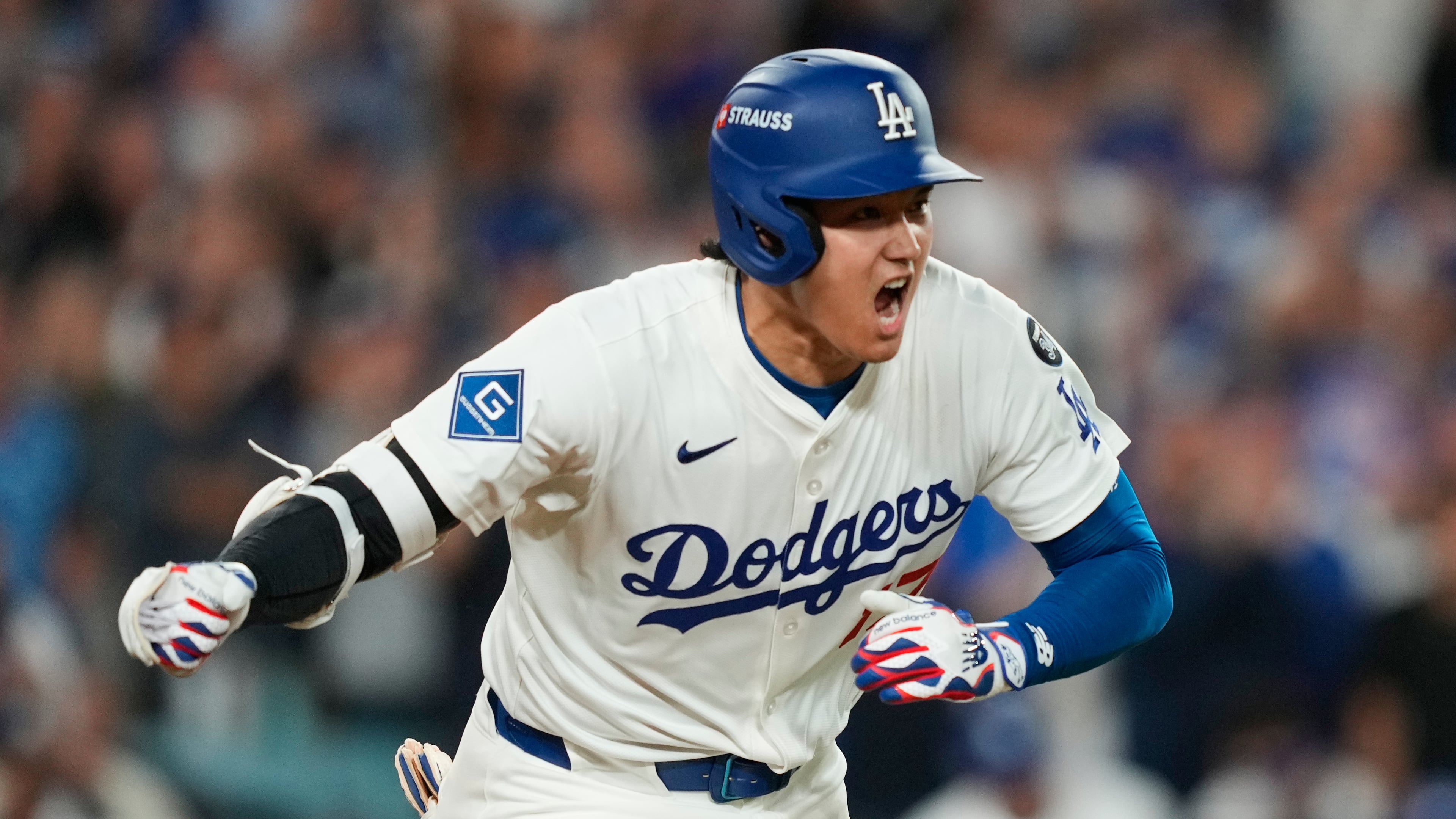 Los Angeles Dodgers' Shohei Ohtani reacts as he drives in a run with a single during the sixth inning in Game 2 of the National League Wild Card baseball playoff series against the Cincinnati Reds, Wednesday, Oct. 1, 2025, in Los Angeles. (AP Photo/Mark J. Terrill)