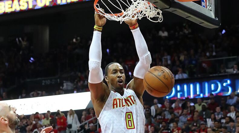 Atlanta Hawks’ Dwight Howard dunks over Washington Wizards Marcin Gortat in Game 4 of a first-round NBA basketball playoff series on Monday, April 24, 2017, in Atlanta. Curtis Compton/ccompton@ajc.com