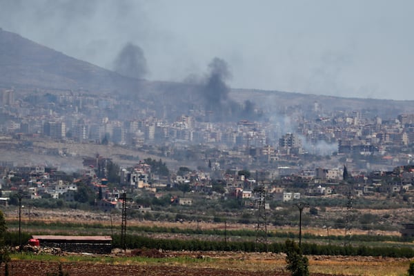 Smoke rise from clashes between Syrian government forces and Druze militias in Sweida city, southern Syria, Tuesday, July 15, 2025. (AP Photo/Omar Sanadiki)