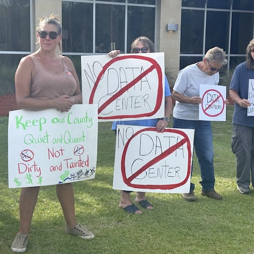 Protesters gather outside the OpenAI data center open house last week. More than 100 Savannah-area residents demonstrated against the project. (Adam Van Brimmer/AJC)