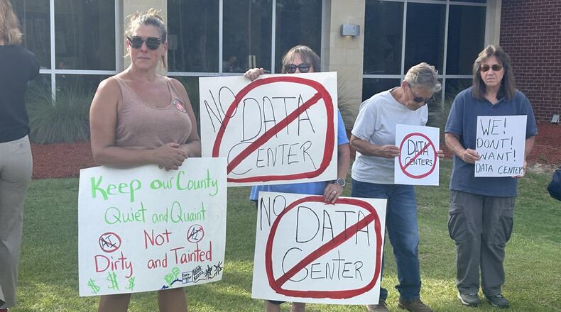 Protesters gather outside the OpenAI data center open house last week. More than 100 Savannah-area residents demonstrated against the project. (Adam Van Brimmer/AJC)