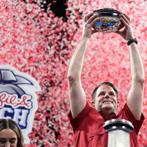 Indiana head coach Curt Cignetti holds up the trophy after the Peach Bowl NCAA college football playoff semifinal against Oregon, Friday, Jan. 9, 2026, in Atlanta. (AP Photo/Brynn Anderson)