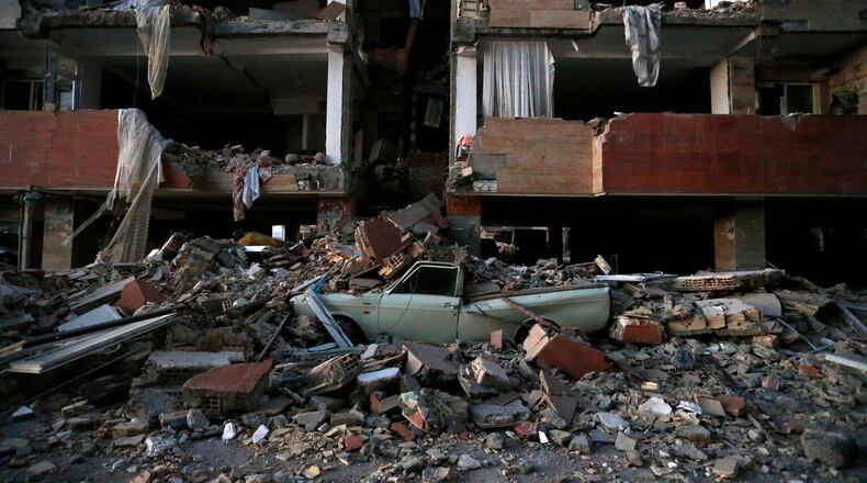 In this photo provided by the Iranian Students News Agency, ISNA, a car lays smashed by debris from the earthquake at the city of Sarpol-e-Zahab in western Iran, Monday, Nov. 13, 2017. A powerful earthquake shook the Iran-Iraq border late Sunday, killing more than one hundred people and injuring some 800 in the mountainous region of Iran alone, state media there said. (Pouria Pakizeh/ISNA via AP)