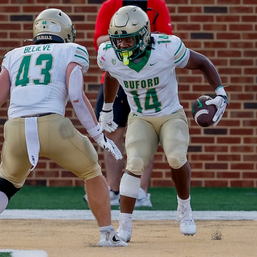 BufordÕs Tripp Chatmon (14) celebrates his touchdown with Jean-Marc Leboehi (43) during the second half of a high school football game between Buford and Gainesville, Saturday, Aug. 22, 2026, in Buford, GA. (Erik S. Lesser for the AJC)